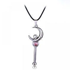 a silver necklace with a pink stone in the shape of a crescent and an upside down moon