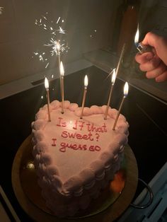 a heart shaped birthday cake with sparklers on it that says is it that sweet i wish to go