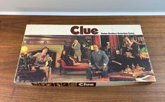 a clue board game sitting on top of a wooden table