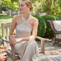 a woman sitting on top of a wooden bench next to a man in a suit