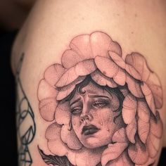 a woman's face with flowers and leaves on her shoulder, as if she was in the moon