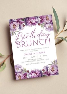 a purple floral birthday brunch is on the table