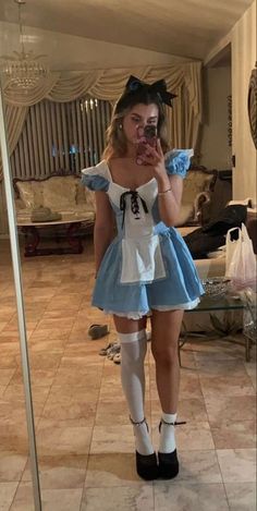 a woman taking a selfie in front of a mirror wearing a dress and socks