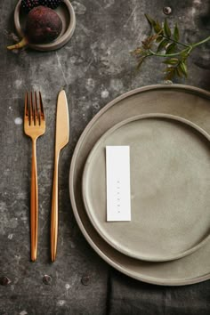 a place setting with a fork, knife and card on the plate next to it