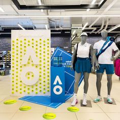 two mannequins dressed in tennis uniforms standing next to each other