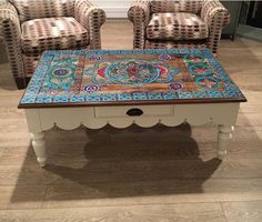 two chairs and a table in a room with tile on the top, one chair is upholstered