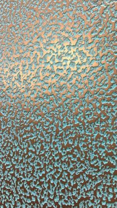 an image of water drops on the glass with brown and blue colors in it, as seen from above