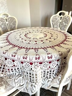 a white table topped with a red and white doily