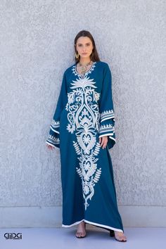 "A flashy extremely vibrant and unique caftan that will make you feel like true royalty. This white embroidered caftan with its unique flared sleeves and vibrant embroidery throughout is a a true stunner! It is an extremely comfortable wear, light and soft and can be used on many occasions -  home gatherings, festival parties, summer occasions, dinners, or just in your home to feel comfortable.  Fabric : 80% Egyptian Cotton; 20% Polyester. Kaftan measurements in inches : -----------Medium------- Blue Long Sleeve Thobe For Eid, Embroidered Blue Long Sleeve Abaya, Long Sleeve Blue Abaya With Floral Embroidery, Traditional Blue Floor-length Kaftan, Blue Long Sleeve Thobe With Dabka, Blue Long Sleeve Thobe With Dabka Details, Blue Dabka Maxi Length Abaya, Bohemian Maxi Dress With Dabka, Traditional Blue Maxi Length Abaya