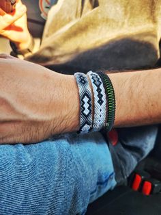 a close up of a person wearing two bracelets