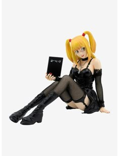 a doll is sitting on the floor with her legs spread out and holding a laptop