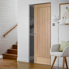 an open wooden door in a white room