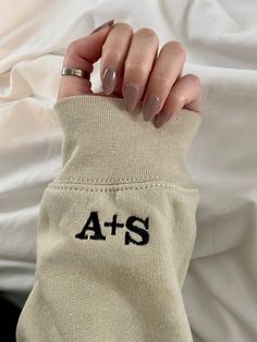 a woman's hand holding onto her arm with the word ats on it