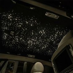 the interior of a car with stars on the ceiling