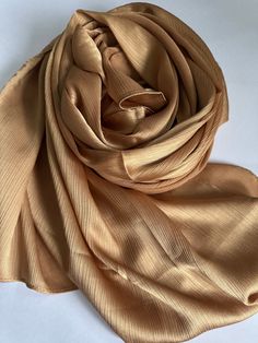 STUNNING LUXURY SOFT DEEP GOLD SCARF Beautiful delicate soft lightweight textured scarf This scarf is a perfect accessory for both daytime and evening wedding wear worn as a shawl & wrap  Made from silk 30% Viscose 70% colour-Deep Gold   188cm length x 140cm width (approx)  Note: The colour of the scarf may appear slightly different in person as screen settings and lighting can affect how it looks on the phone or computer. Luxury Semi-stitched Gold Shawl, Elegant Gold Scarf For Wedding, Elegant Gold Shawl-style Dupatta, Elegant Gold Shawl-shape Dupatta, Elegant Gold Shawl Dupatta, Elegant Gold Silk Shawl, Wear Shawl, Luxury Champagne, Gold Scarf