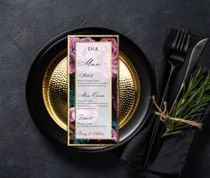 a black plate topped with a menu next to a fork and knife on top of a table