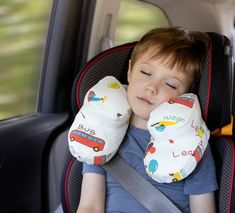 a young boy sleeping in the back seat of a car