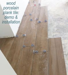 the wood floor is being installed with plywood planks and demo & installation tape