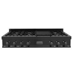 a black stove top with four burners and two knobs on it's side