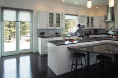 a man standing in the middle of a kitchen