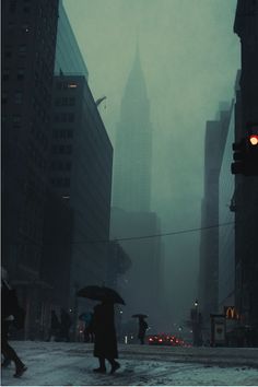 people walking in the rain with umbrellas on a city street near tall buildings and skyscrapers