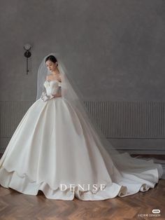 a woman in a wedding dress posing for the camera