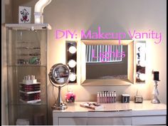 a vanity with lights and makeup products on it