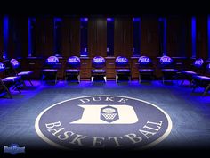 the duke basketball hall is lit up with blue lights and chairs in front of it