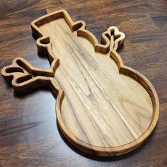 a wooden cutting board shaped like a frog