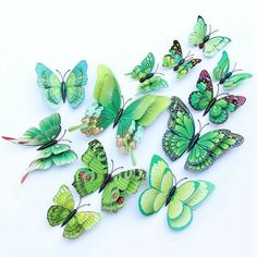 a group of green butterflies sitting on top of a white table next to each other