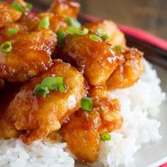 chicken and rice on a plate with chopsticks