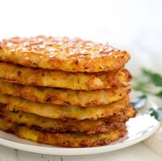 a stack of pancakes on a white plate