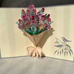 a bouquet of flowers sitting on top of a card