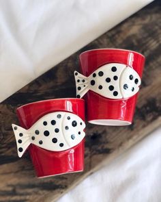 two red cups with black polka dots on them