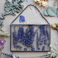 blue flowers are displayed in an old metal frame