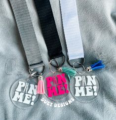 three lanyards that say pin me, pin me, and pin me but designs