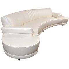 a white leather couch sitting on top of a table