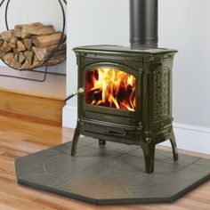 a wood stove with logs in the background