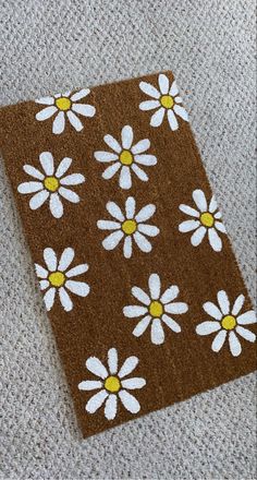 a brown and white flowered rug on the floor next to a cell phone charger