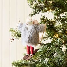 an ornament hanging from a christmas tree with red socks and boots on it