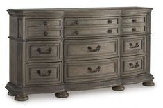 a large dresser with many drawers and knobs on the bottom drawer, in grey wood