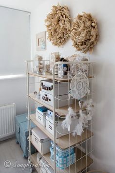 a shelf filled with lots of items next to a wall