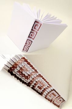 an open book sitting on top of a white table next to a knife and fork