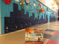 a book sitting on the floor in front of a wall with balloons hanging from it