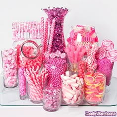 there are many pink and white candies in vases