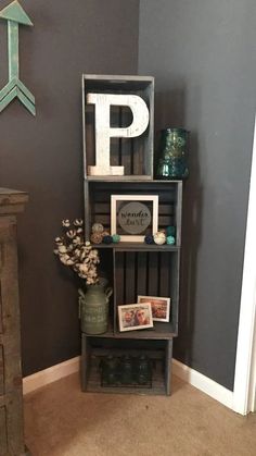 a book shelf with letters and pictures on it next to a dresser in a room