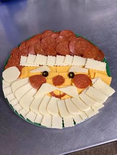 a pizza with cheese and meats on it is shaped like a santa claus face