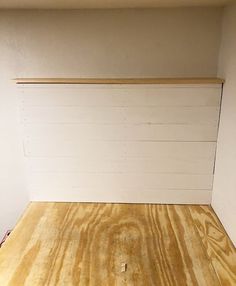 an empty room with wood flooring and white paint on the walls, along with no furniture