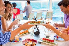 people sitting at a table with plates of food