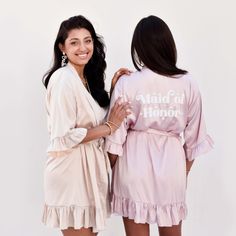 two women standing next to each other in robes